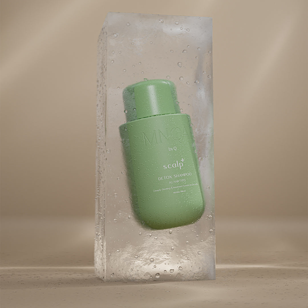 Green bottle with label inside a block of ice on a beige background