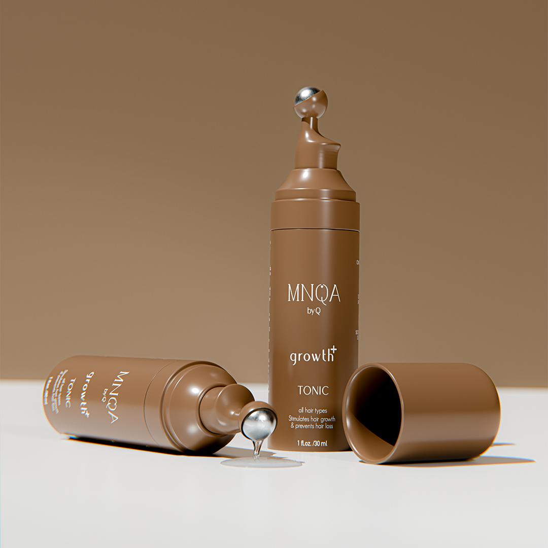 Brown bottle labeled 'MNQA' with 'growth tonic' on a beige background