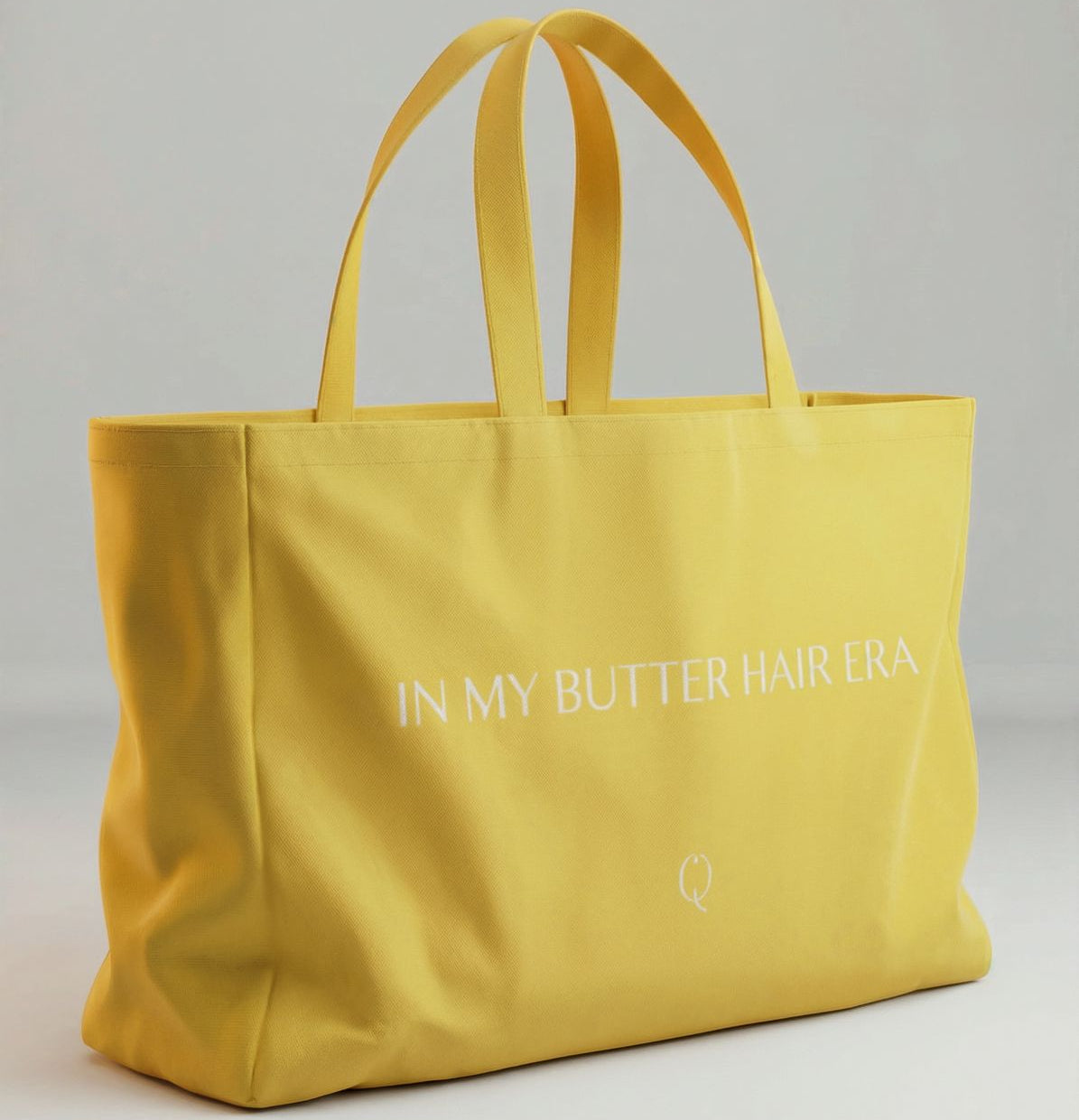 Yellow tote bag with text on a gray background